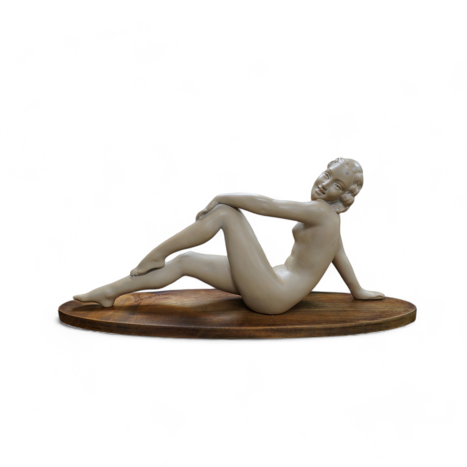 An Art Deco composition figure of a reclining nude, 73cm long. Condition - restored